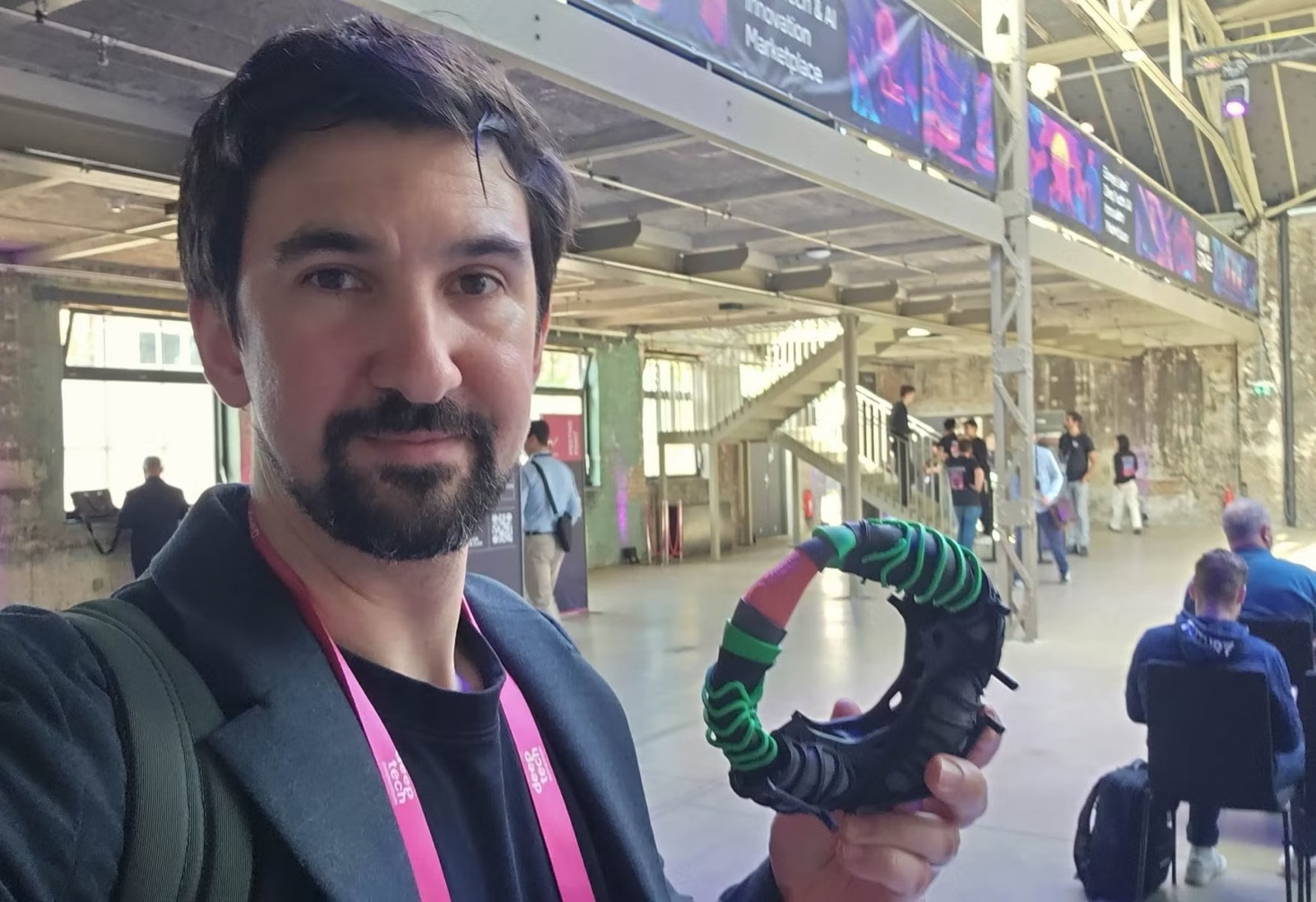 Dr Ben Miles holding deep-tech hardware at a conference
